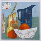 Two Oranges and Daisy" is a still life painting with a white daisy in a patterned vase, a tall blue jug, a white bowl with yellow circles, and two oranges on a green surface against a blue-grey background.